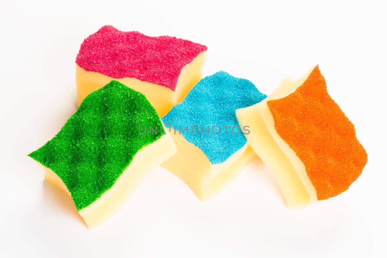 Four colorful sponges for cleaning are on white background.