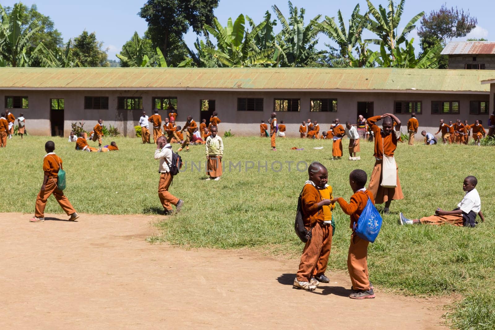 Arusha, Tanzania- Jan 26, 2015: Children in uniforms playing in the cortyard of primary school on January the 26th, rural area near Arusha, Tanzania, Africa.