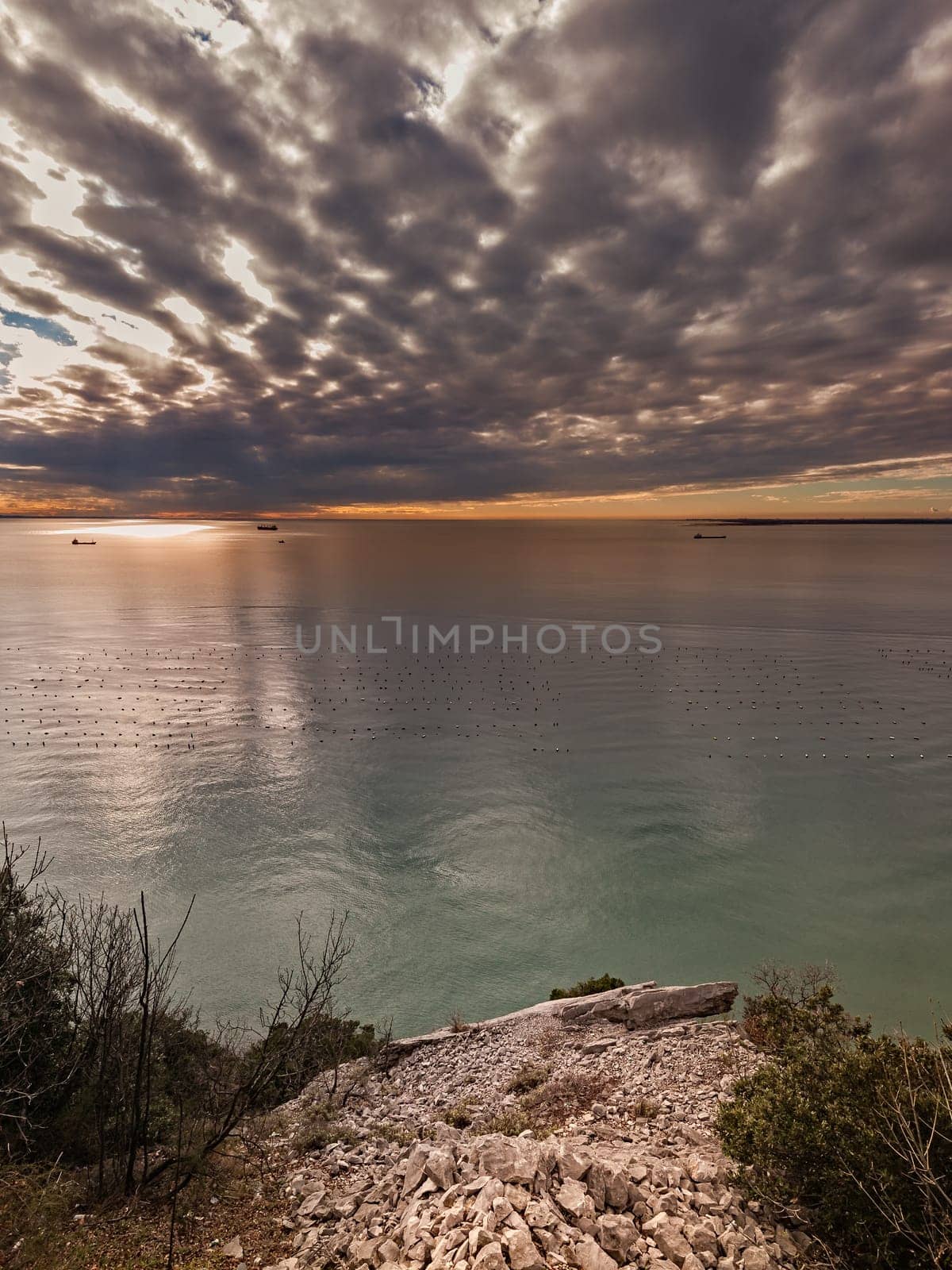 Seascape with sky overcast at sunset or sunrise with ships
