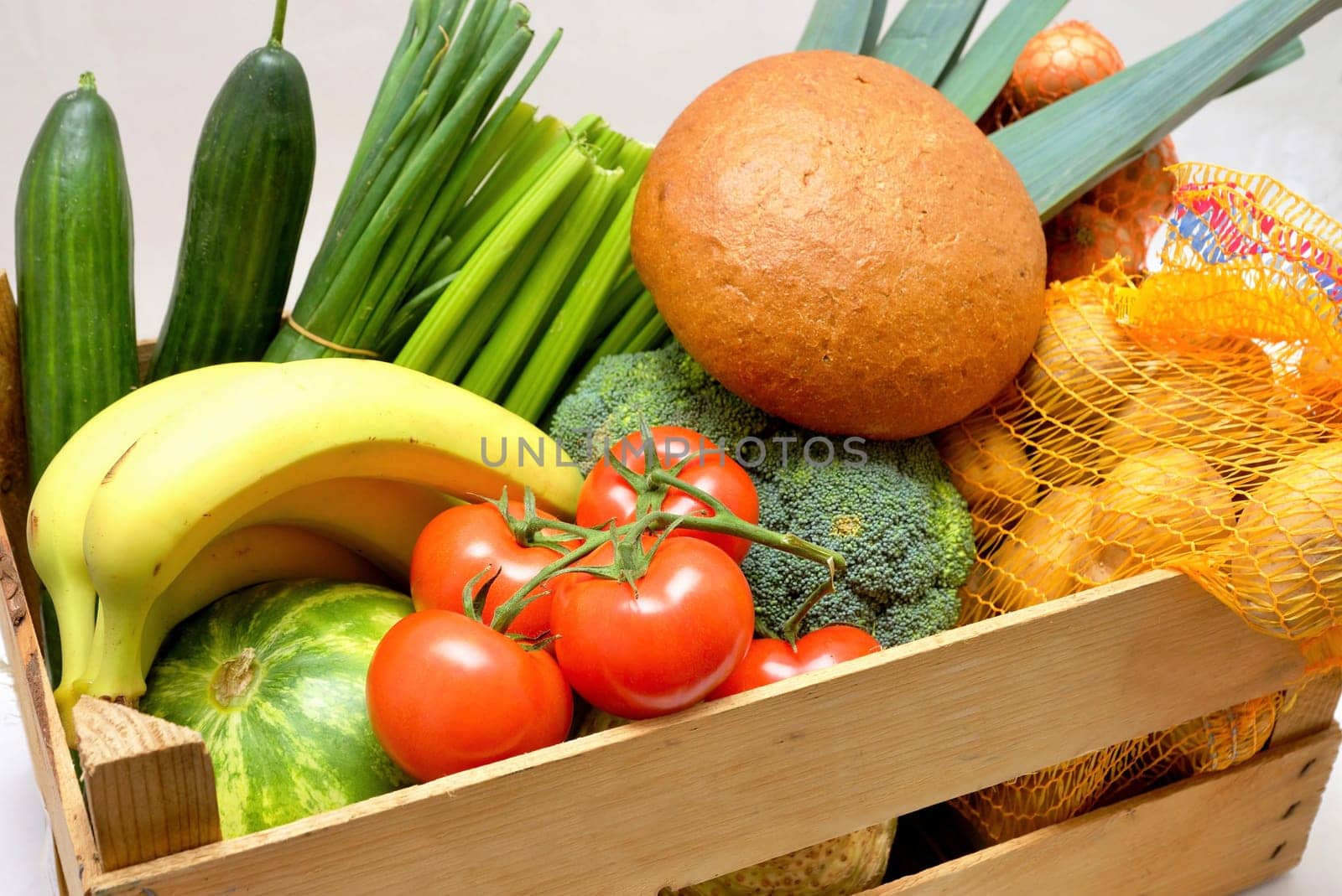 Fruit,vegetables and bread in a wooden box