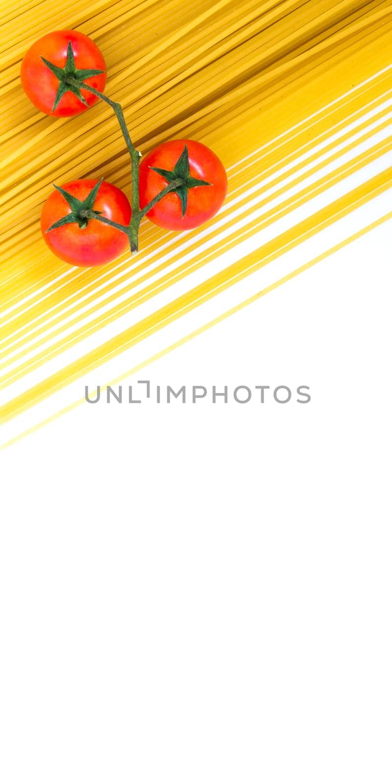 Spaghetti and cherry tomatoes isolated on white background. Uncooked Italian dried spaghetti. Flat lay. Copy space.