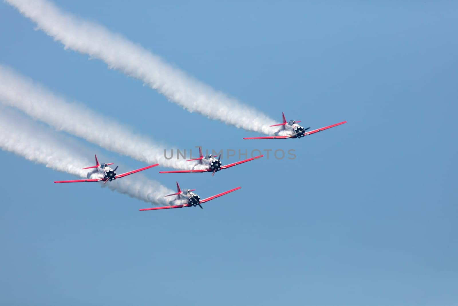 USA, Chicago - August 19: Aeroshell T-6 Aerobatic team performing at Chicago Air and Water Show, with smoke to track the high flying planes on August 19, 2017