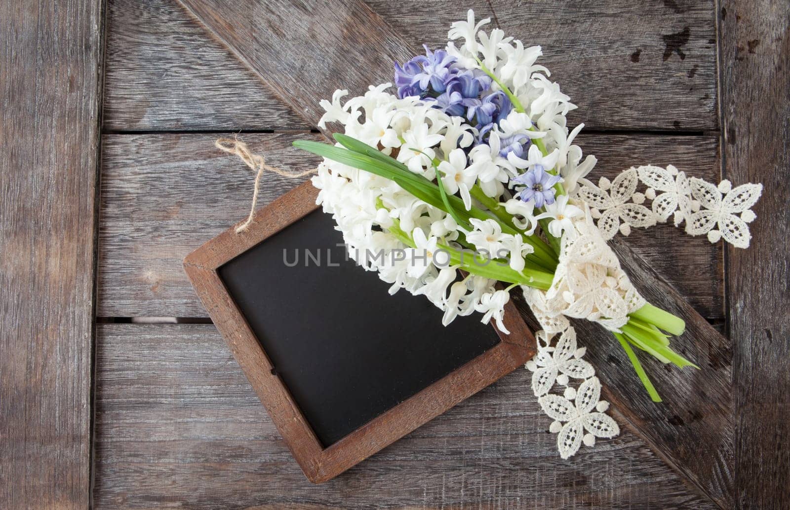 Small bouquet of fresh hyacinths on a rustic wooden background
