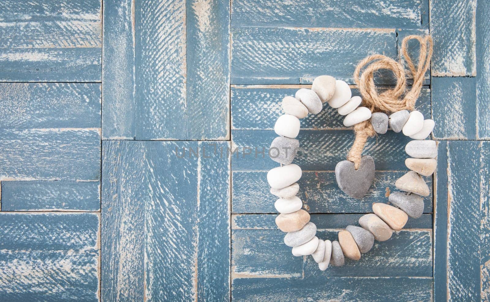 Heart of pebbles and rustic background of wood