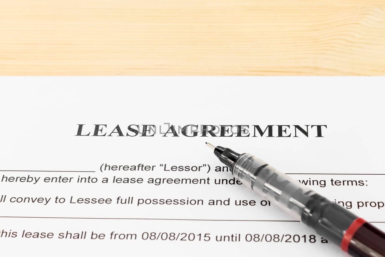 Lease Agreement Contract Document and Pen Horizontal View on Wood Table. Legal document for business event