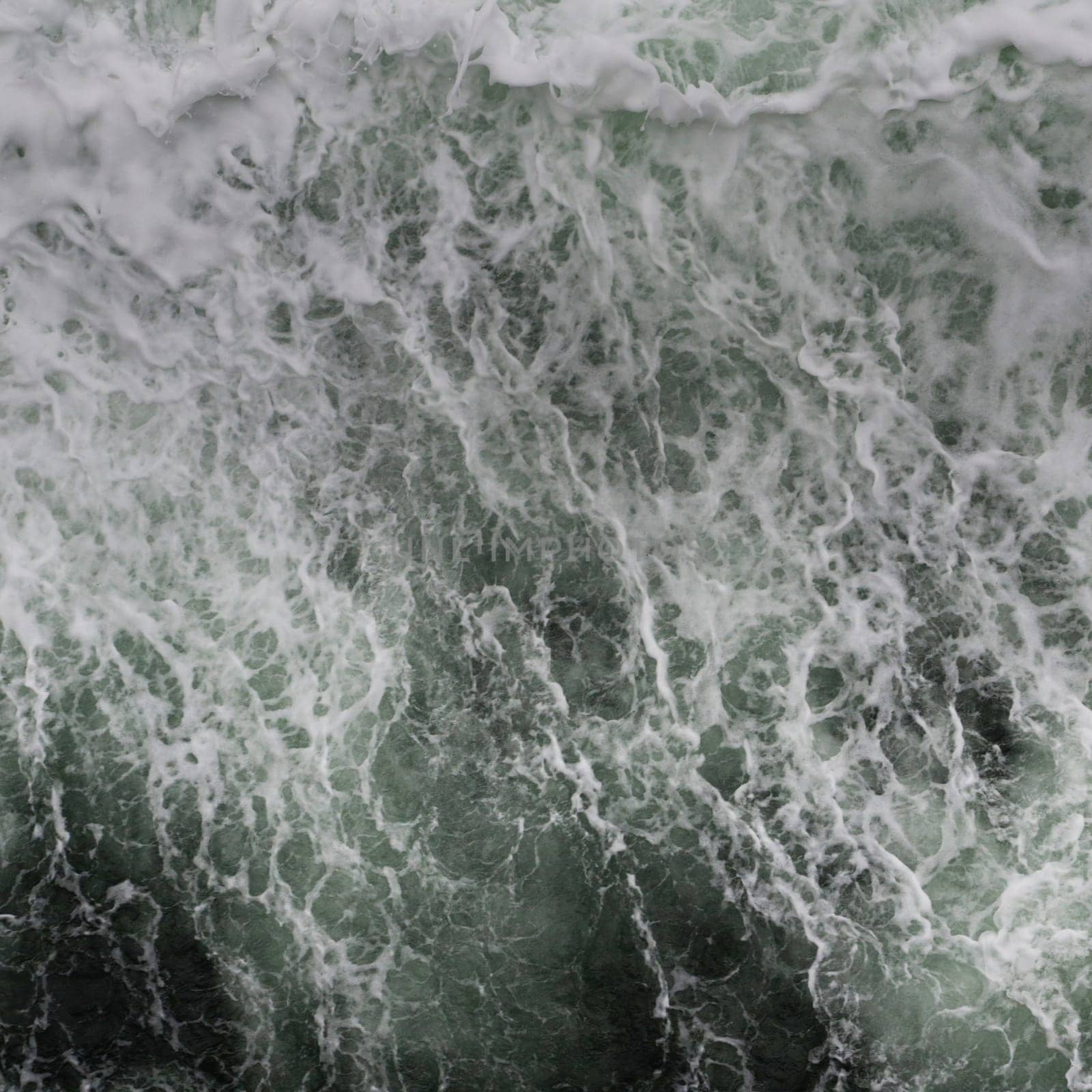 Big water splash seen from above a boat