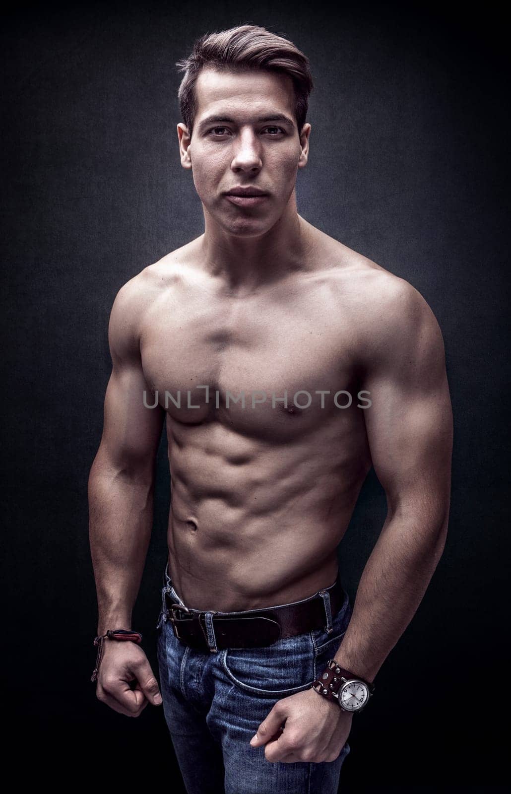 Handsome young strong man posing bare chest