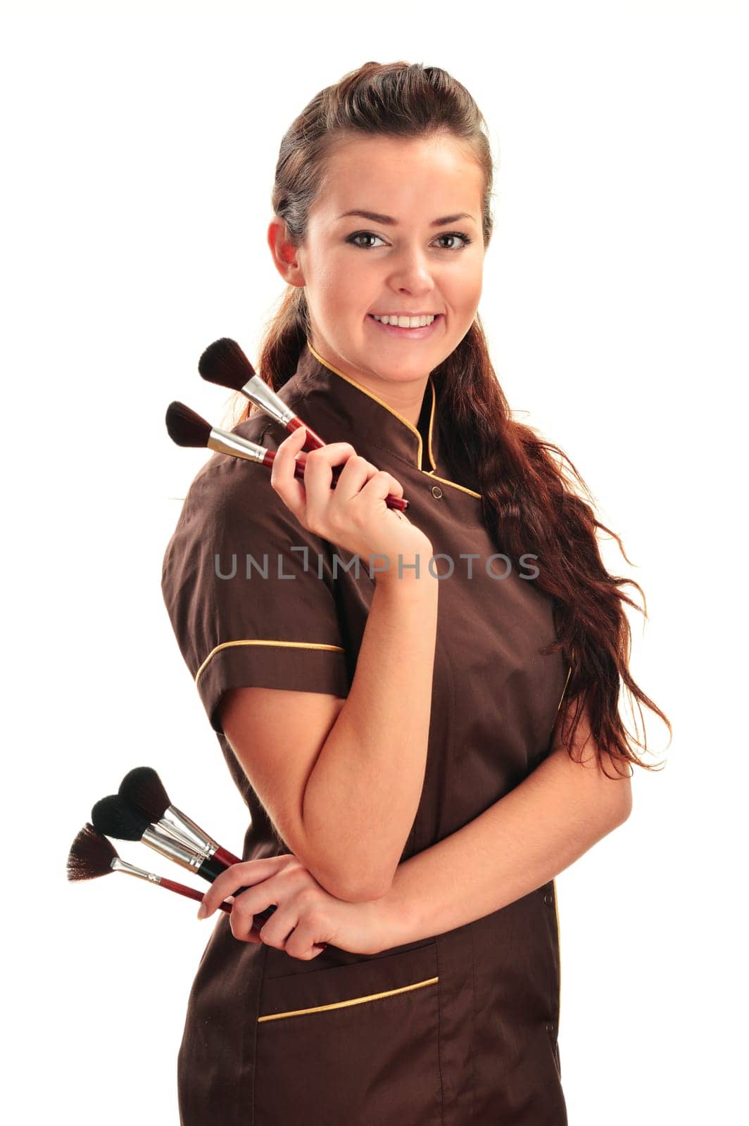 Professional beautician holding brushes