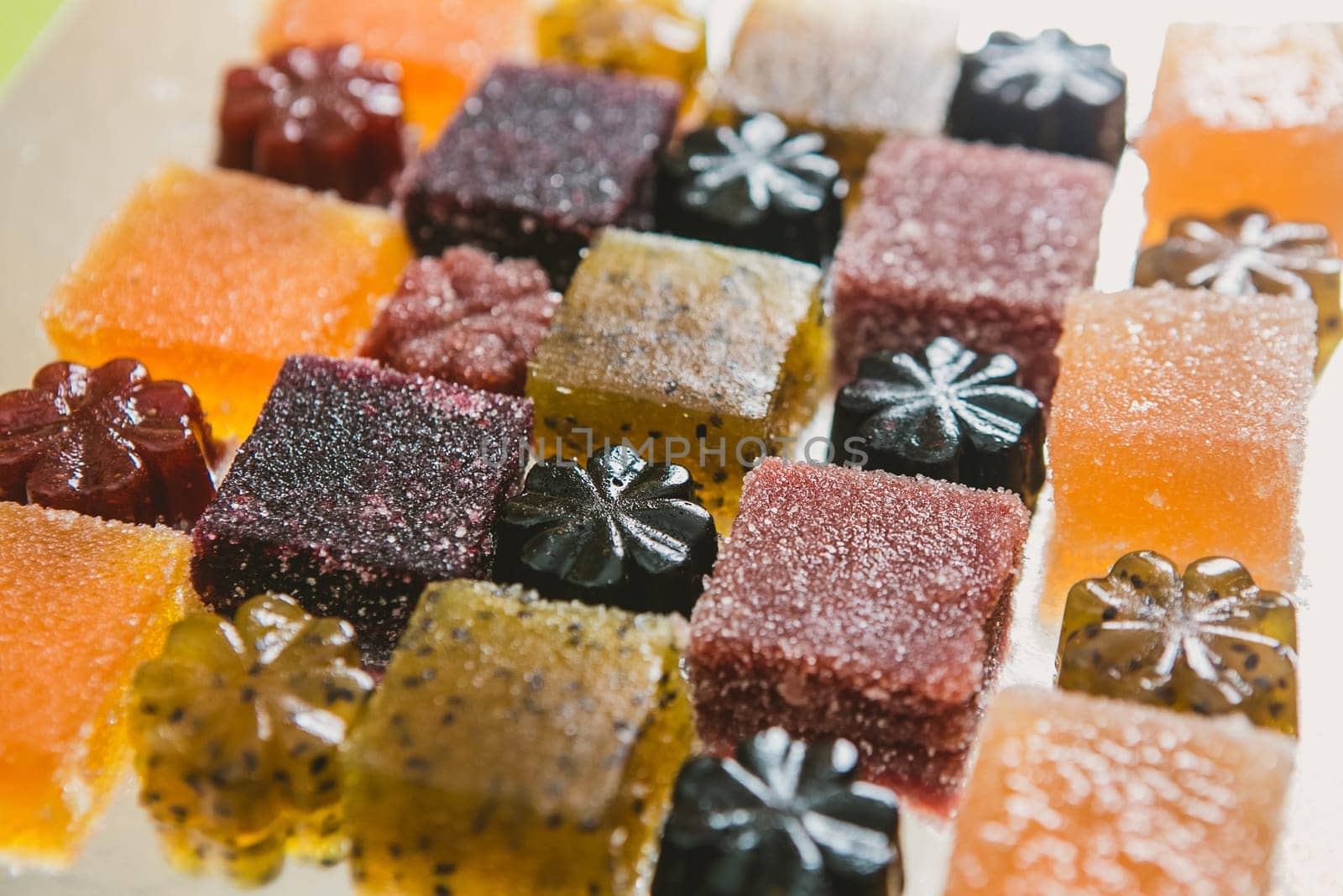 Many different fruit paste candies. Whole background. Selective focus. warm colors