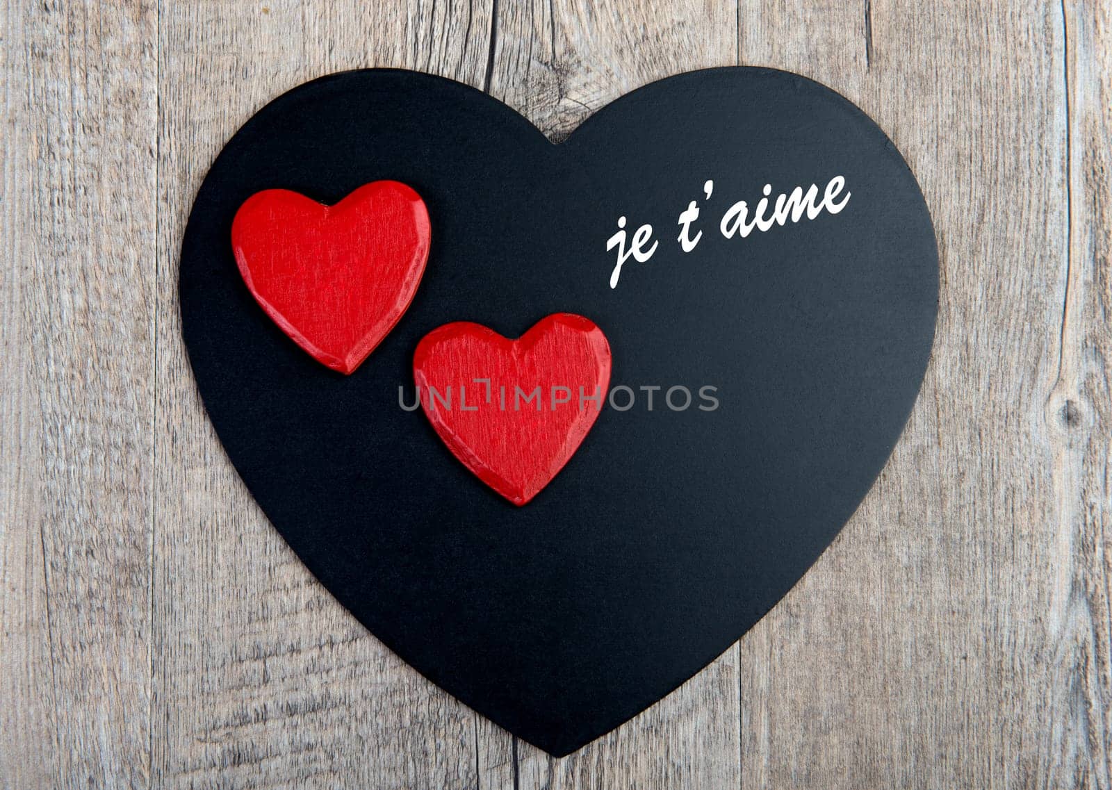 black and red hearts for Valentine's Day on the wooden table