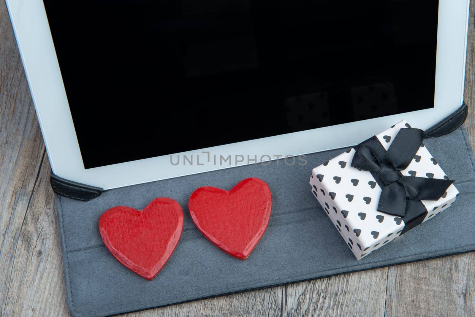 a heart and a gift with a digital tablet