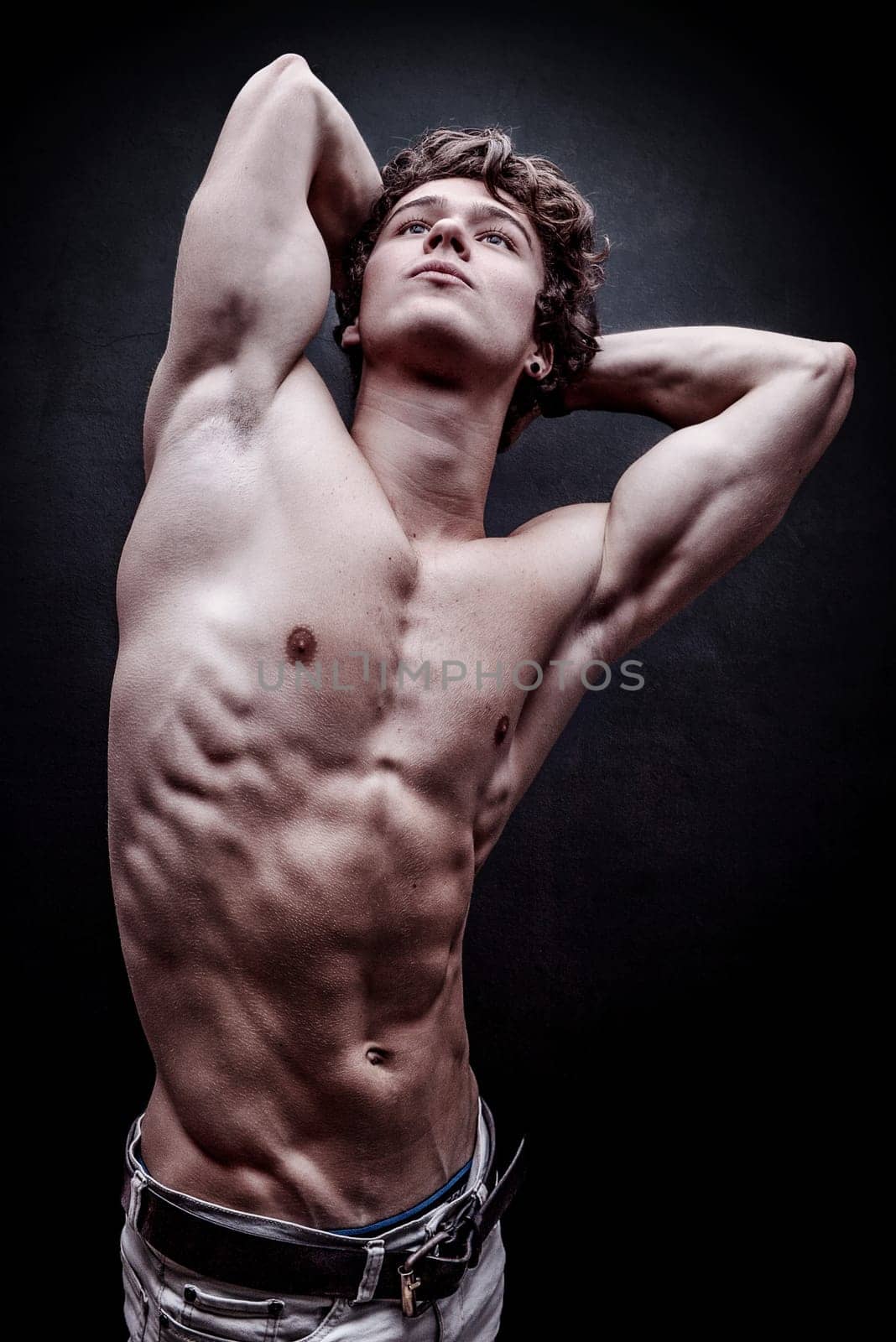 Young handsome man looking up and stretching