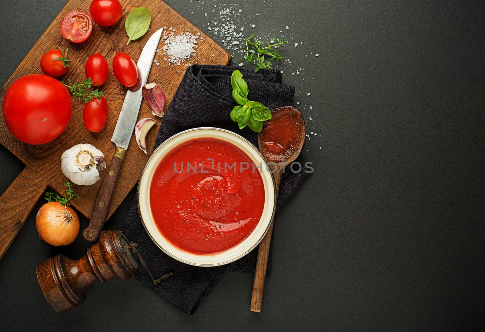 Fresh ingredients for cooking tomato sauce or soup on wooden background place for text. Vegan food vegetarian and healthy cooking concept.