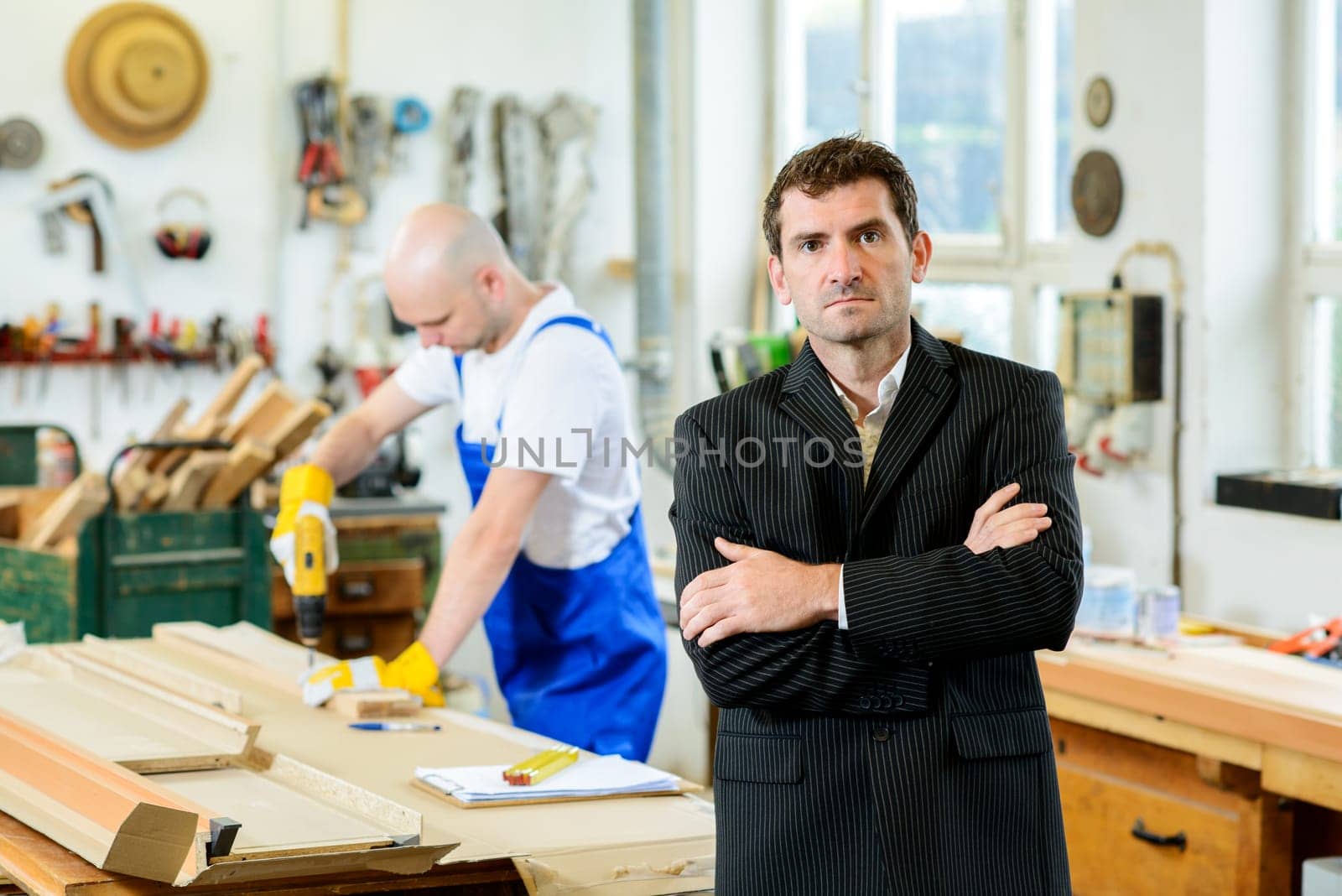 boss and worker together in a carpenter's workshop