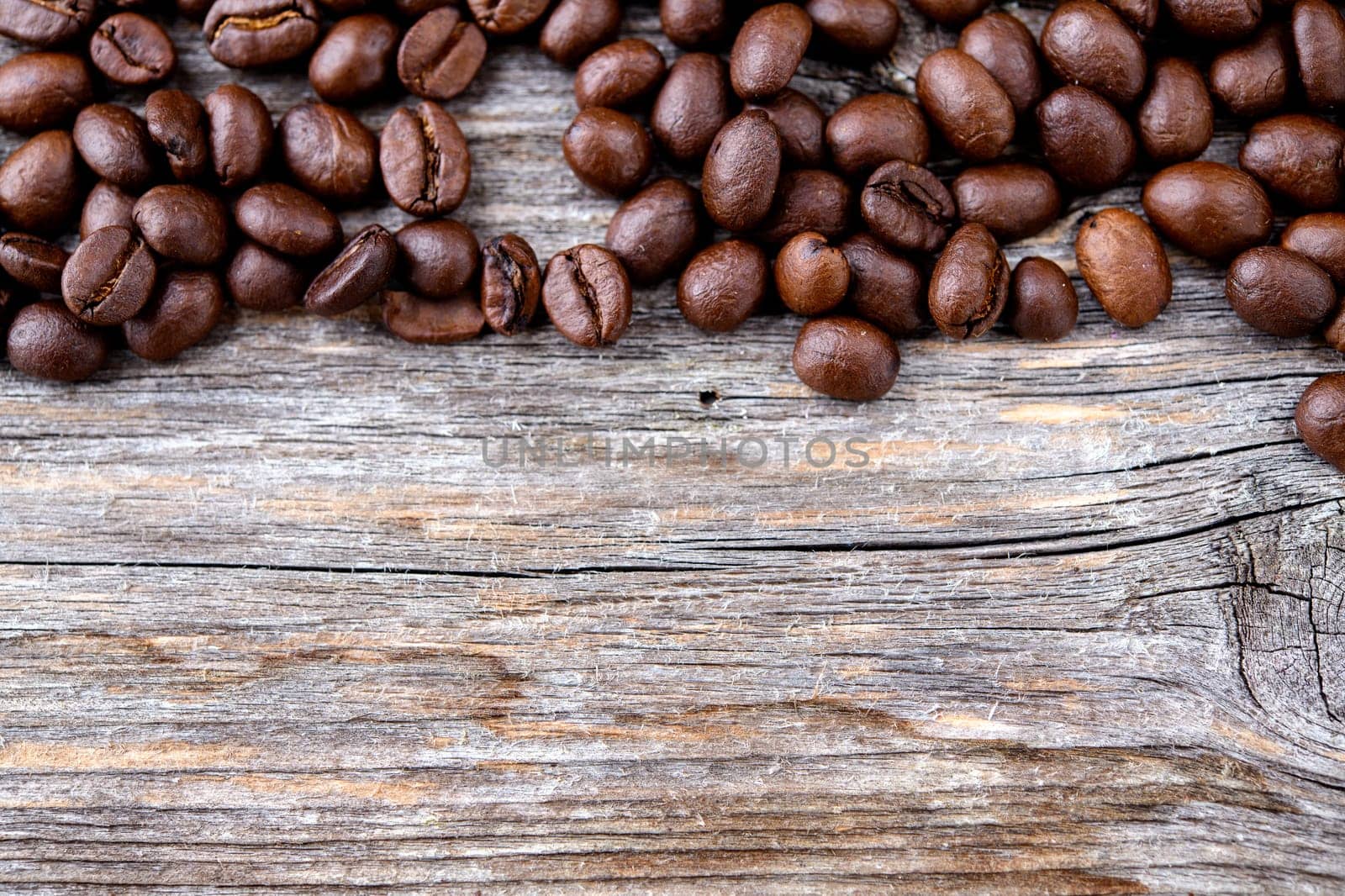 brown roasted coffee beans on wooden ground
