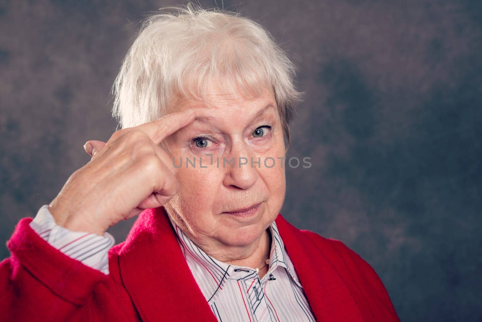 gray hairy elderly woman looking angry and showing a bird