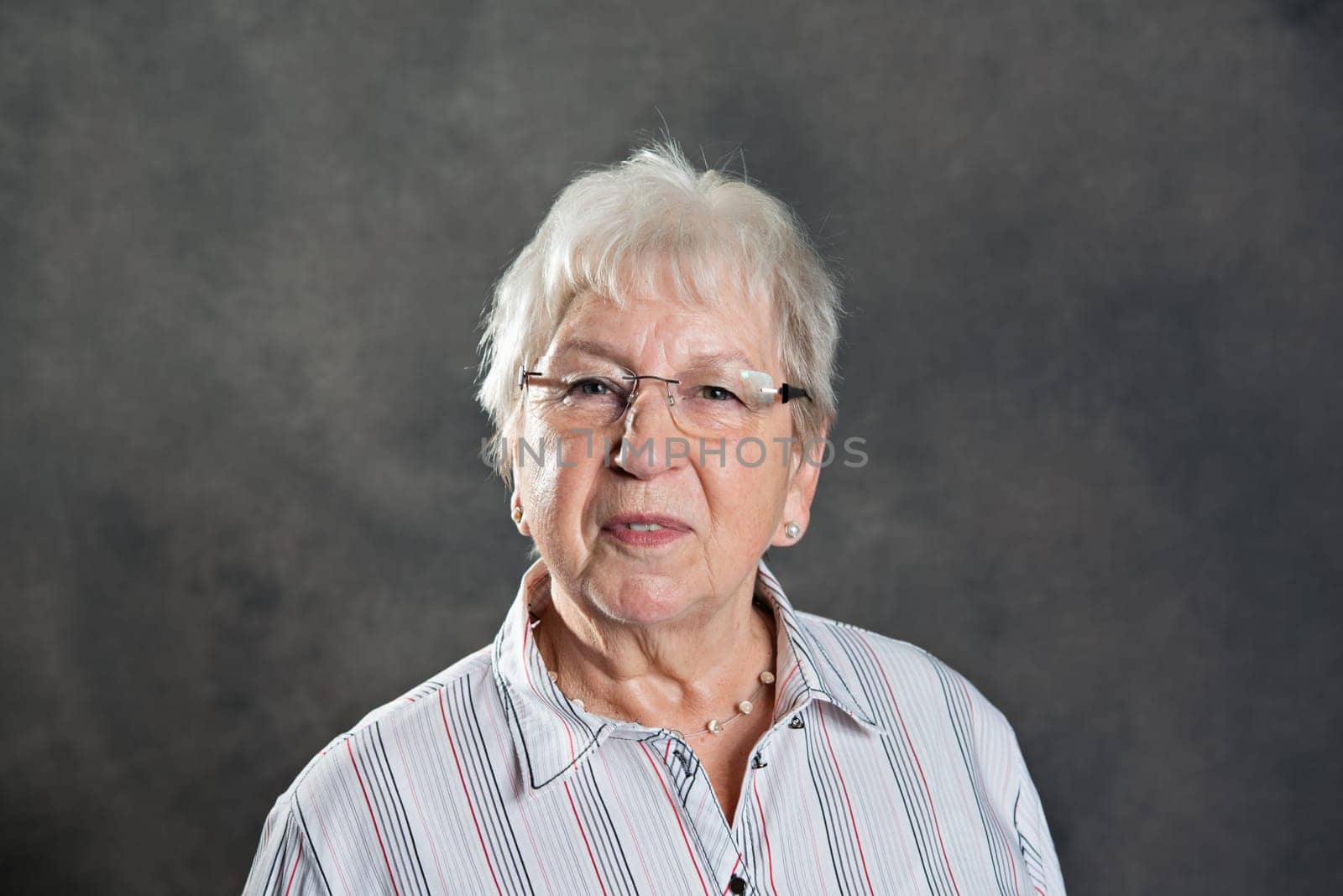 gray hairy elderly woman looking friendly