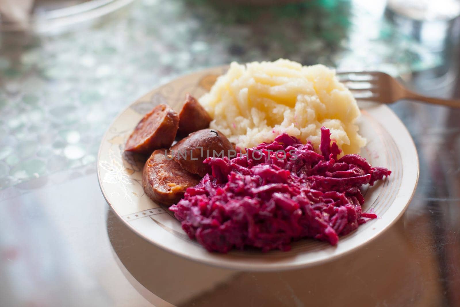 Meat sausage with potato puree and salad of beet