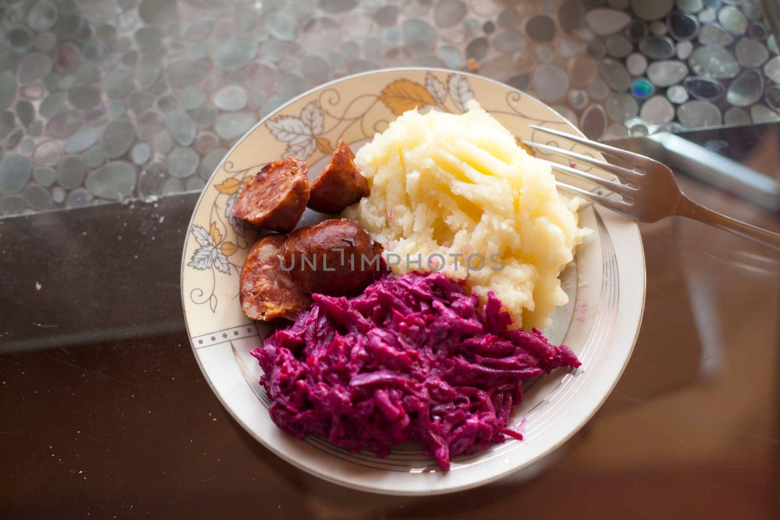 Meat sausage with potato puree and salad of beet