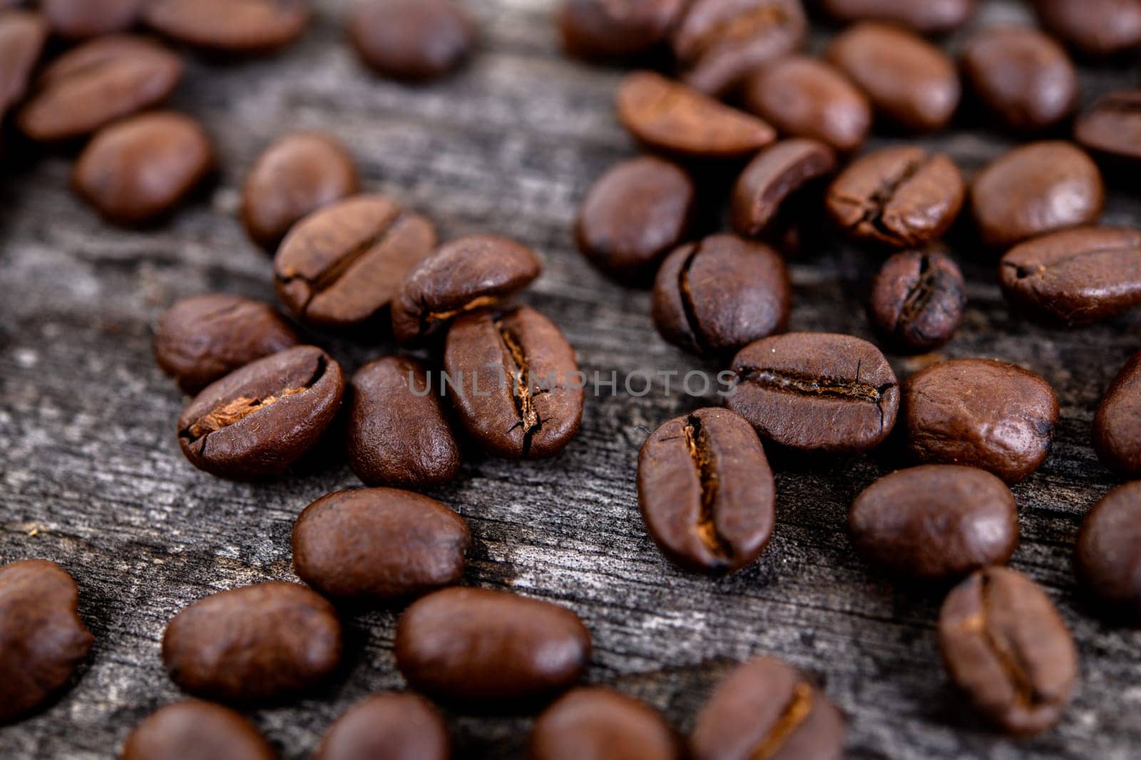 brown roasted coffee beans on wooden ground