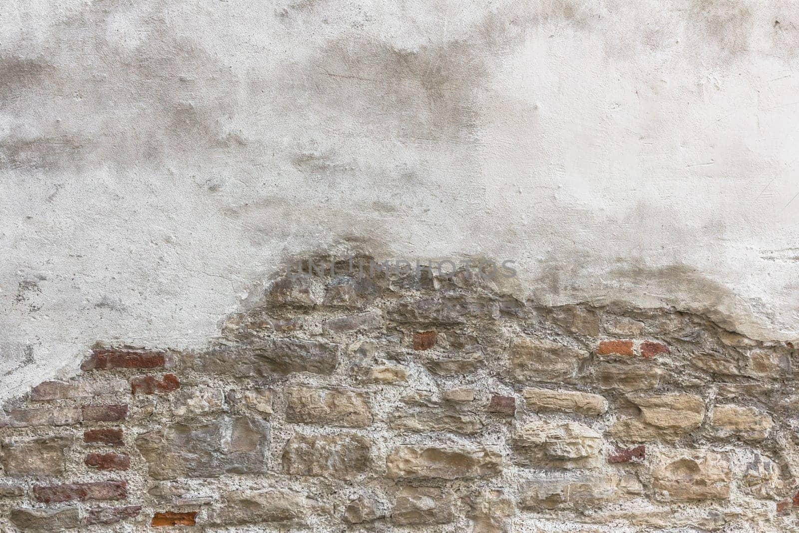Old bricks with partial white plastered wall texture