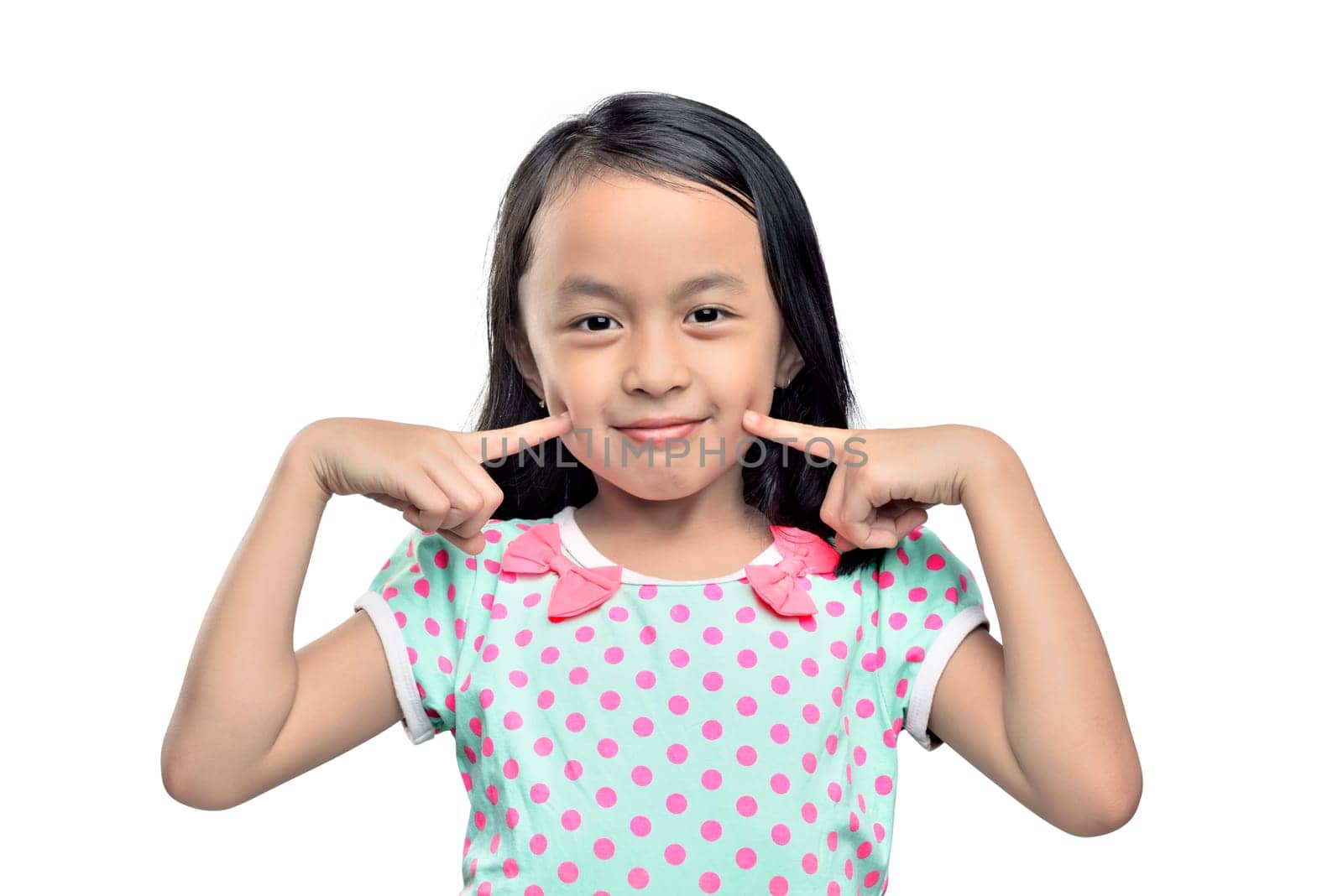 Portrait of asian little girl with fingers on cheek posing isolated over white background