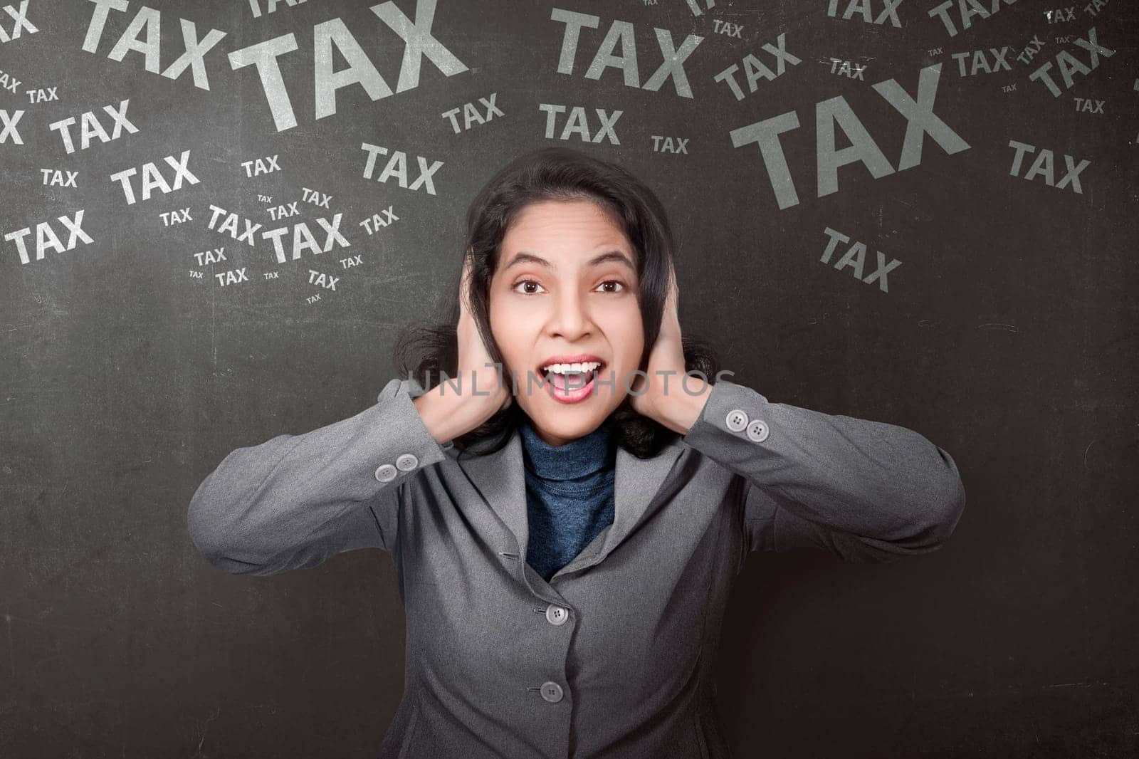 Stressful asian businesswoman with tax sign on black wall background