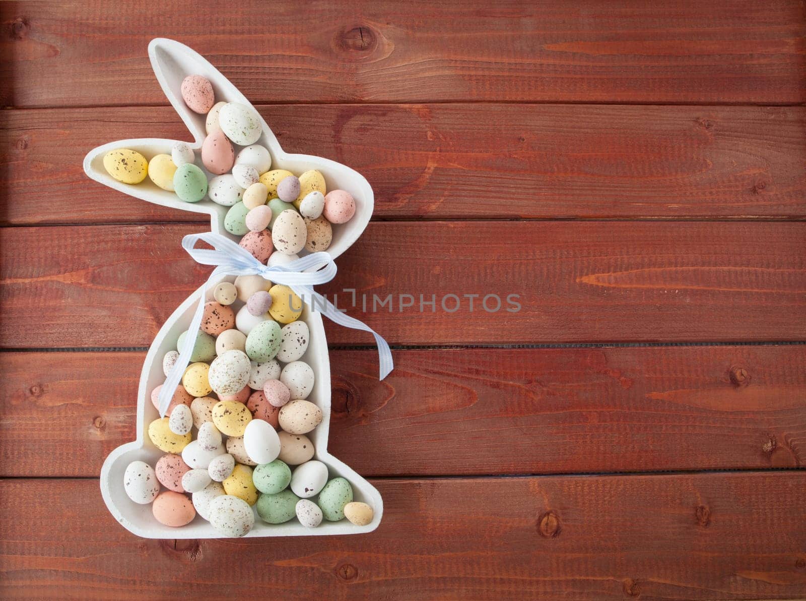 Colorful Easter eggs made of chocolate on rustic wood background