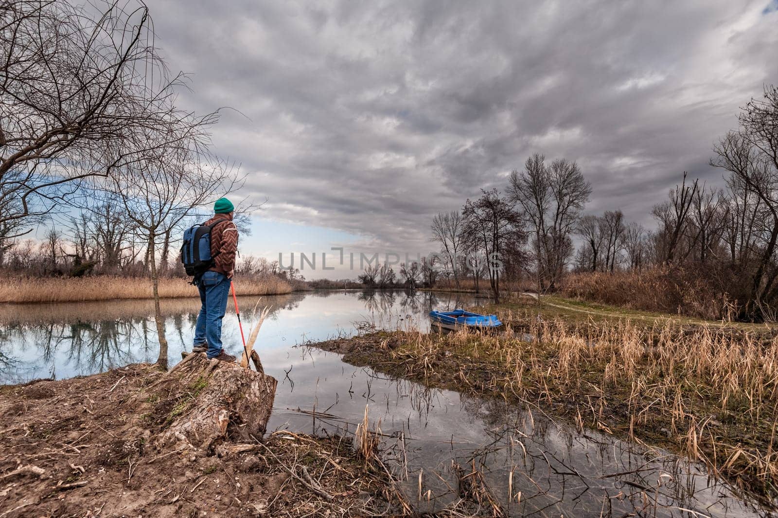 Hiker resting on river bank. Hike and people concept, travel,tourism.