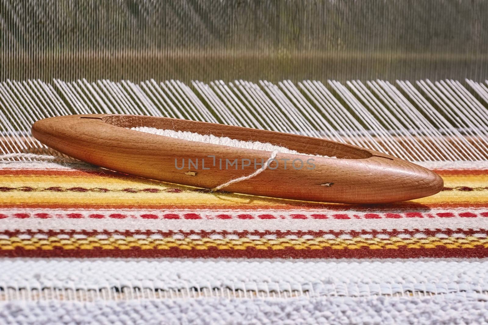 Wooden Shuttle with Bobbin on the Weft Yarn (Shallow DoF)