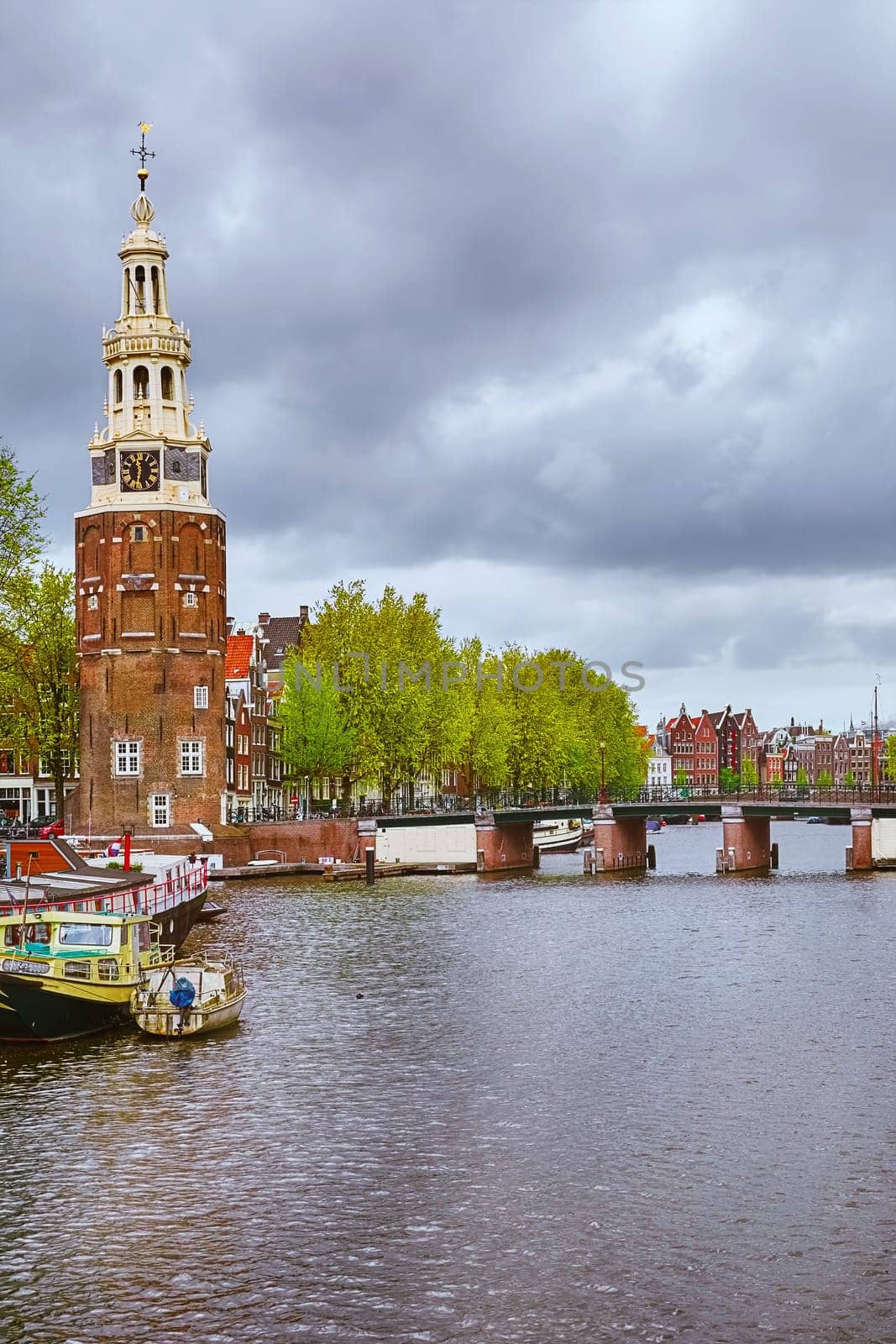 Tower (Montelbaanstoren) on the Bank of the Canal Oudeschans in Amsterdam, Netherlands