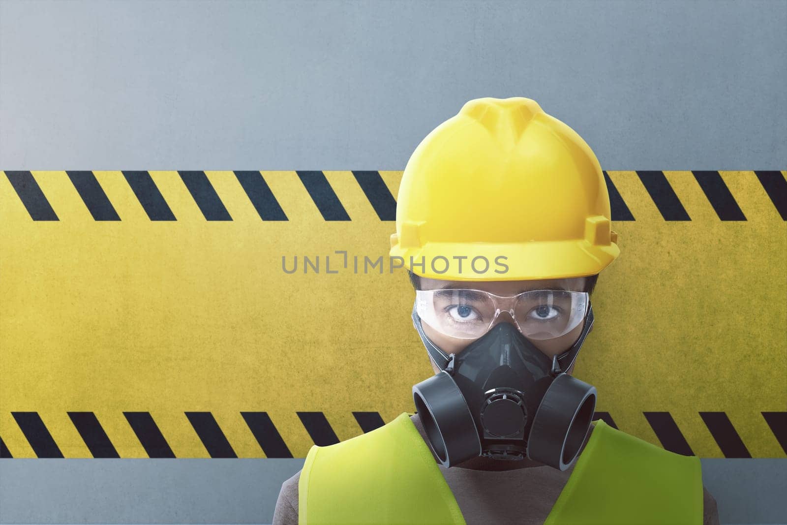 Closeup view of construction worker with protective mask on yellow striped background