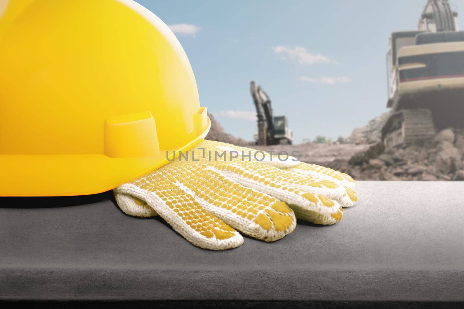 Yellow helmet and gloves on the desk at construction site