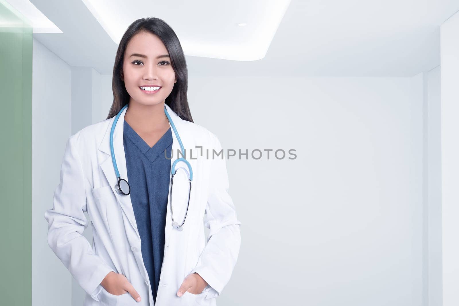 Cheerful asian doctor woman with stethoscope on hospital room