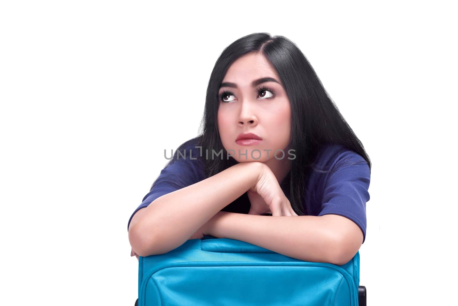Portrait of sad asian woman with suitcase posing isolated over white background