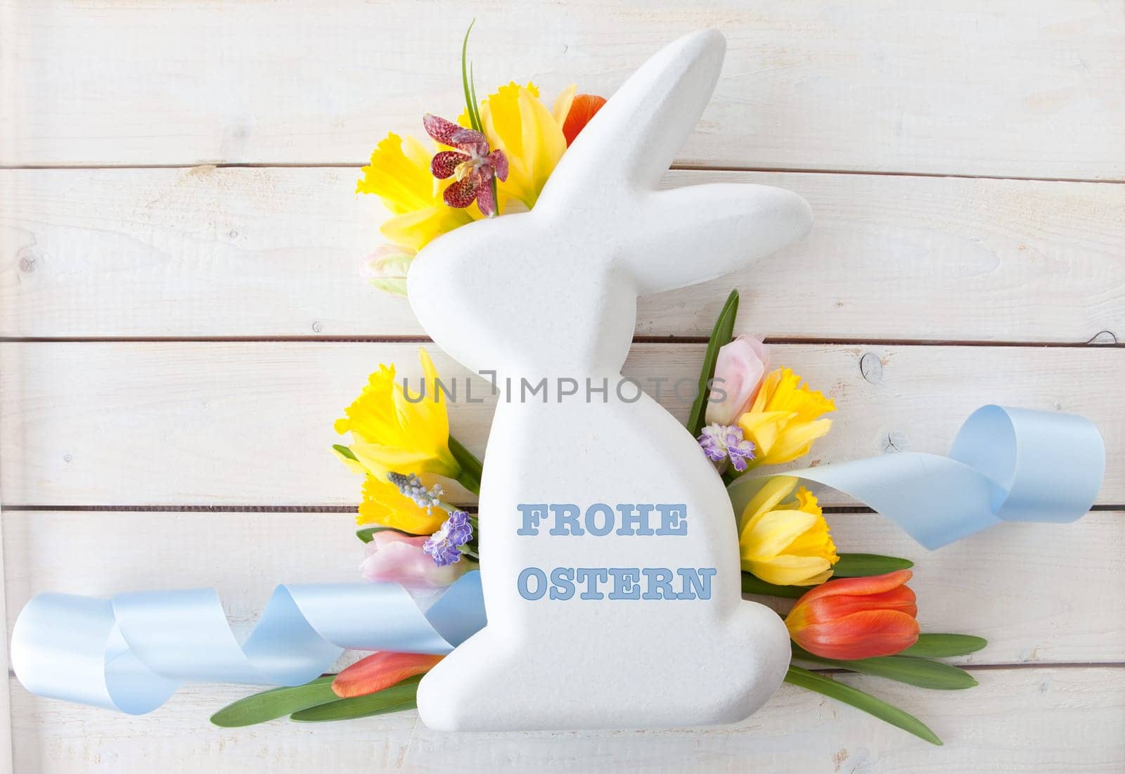 Easter bunny with fresh flowers in Spring