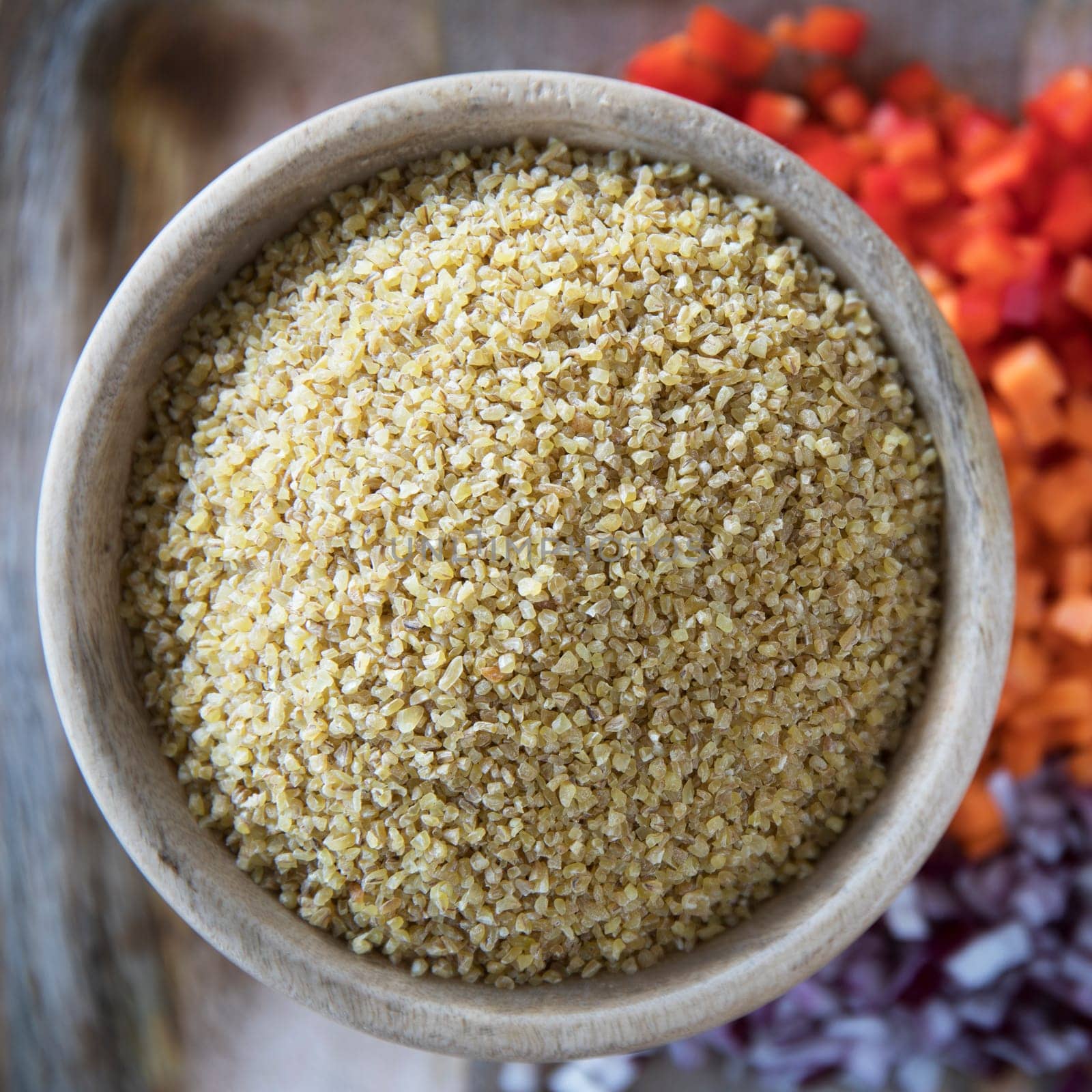 Wooden bowl full of fresh bulgur