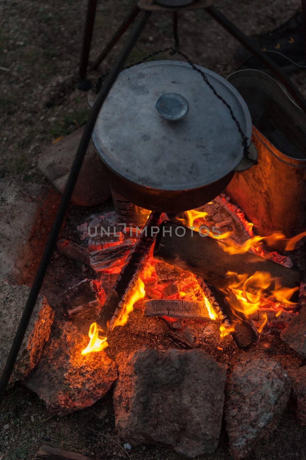 Preparing food on campfire in wild camping, resting on the nature