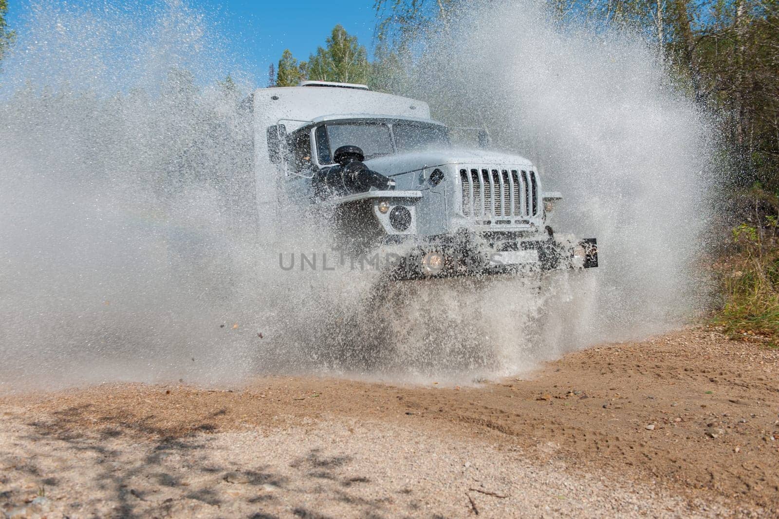 the truck passes through a puddle