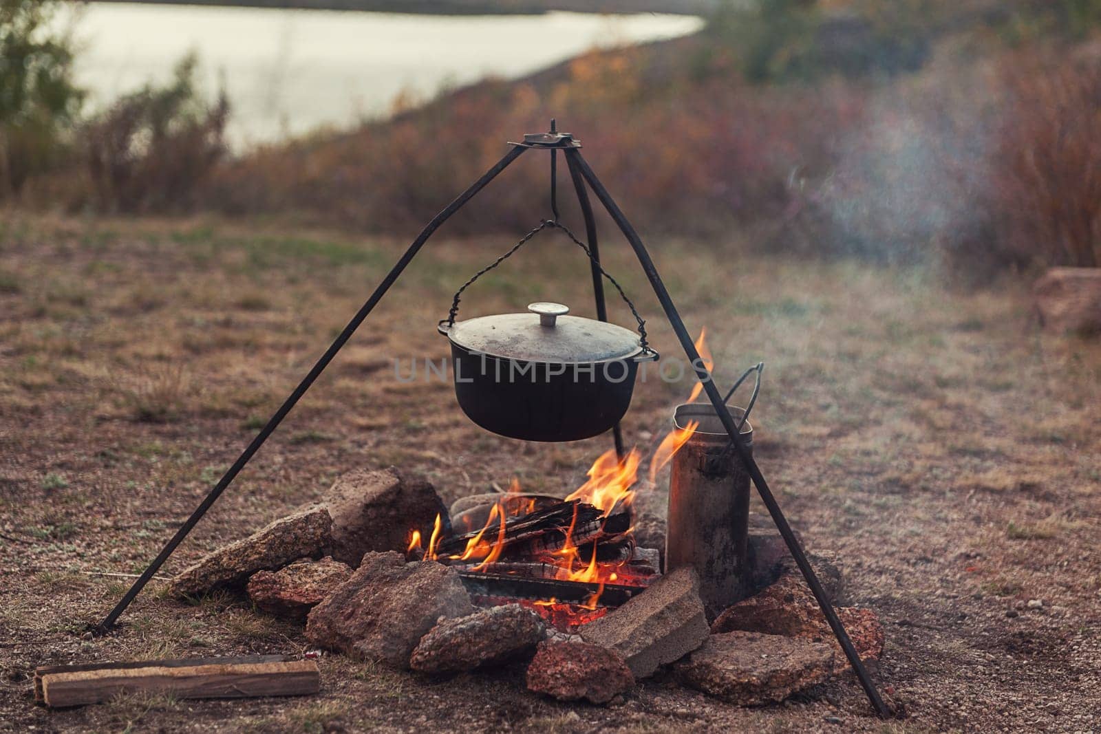 Preparing food on campfire in wild camping, resting on the nature