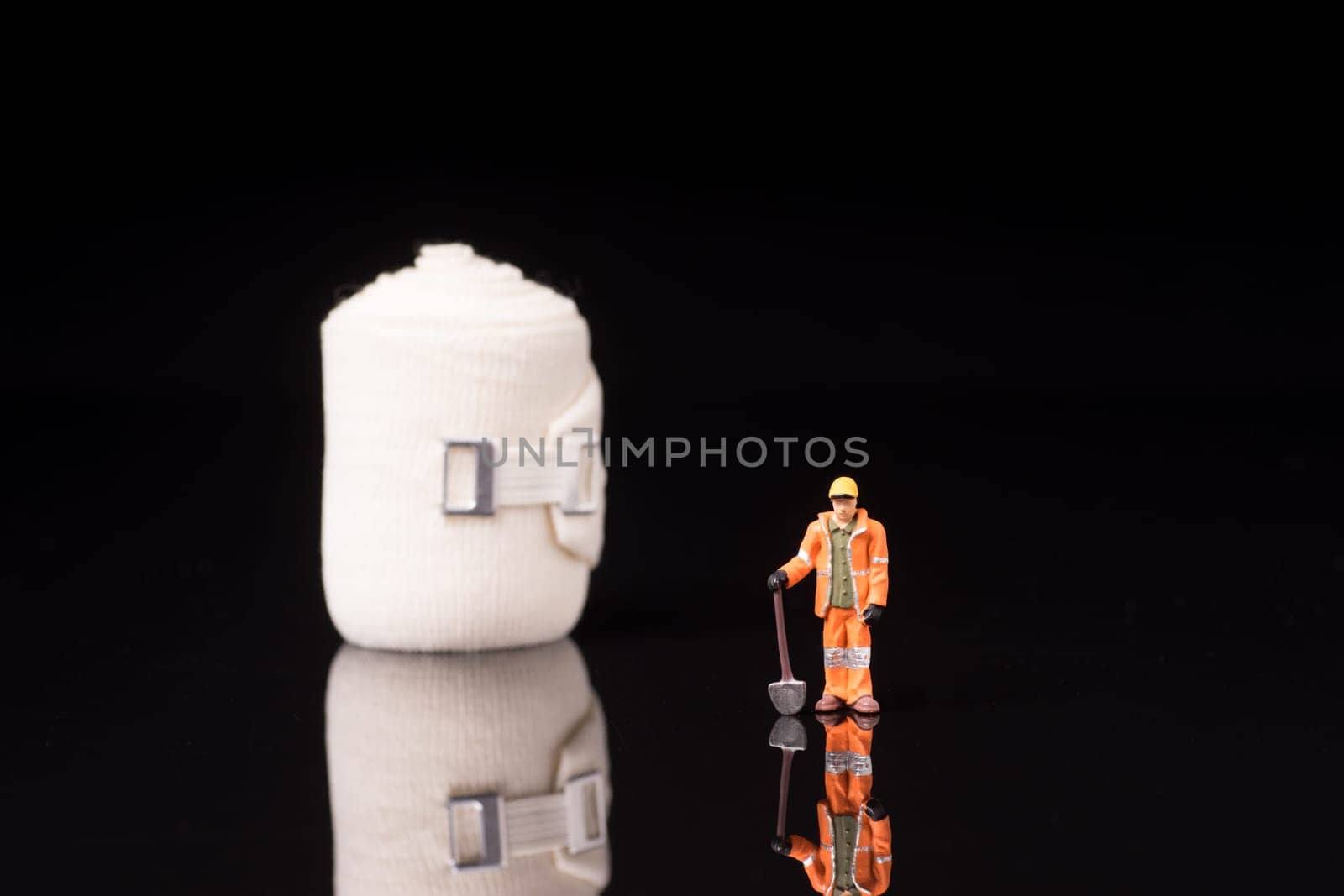 Bandage used for injuries during work, leisure time or in housework, isolated on glossy black background