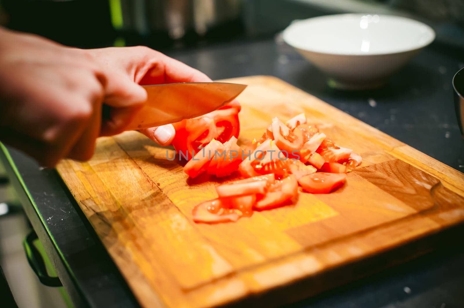 woman housewife in the kitchen. woman cuts vegetables, cooking, knife on a cutting board. Hands cooks close up