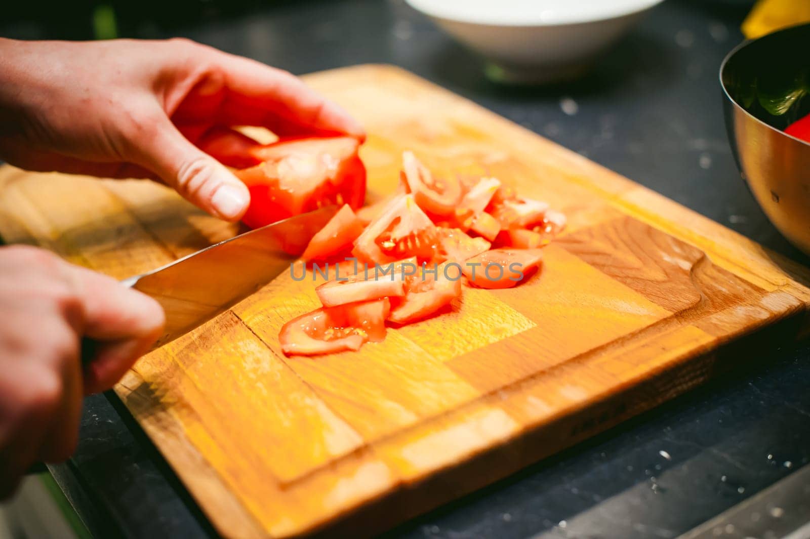 woman housewife in the kitchen. woman cuts vegetables, cooking, knife on a cutting board. Hands cooks close up