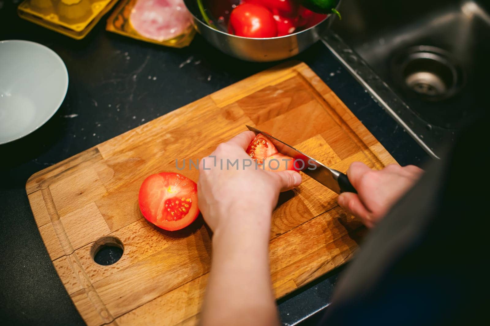 woman housewife in the kitchen. woman cuts vegetables, cooking, knife on a cutting board. Hands cooks close up