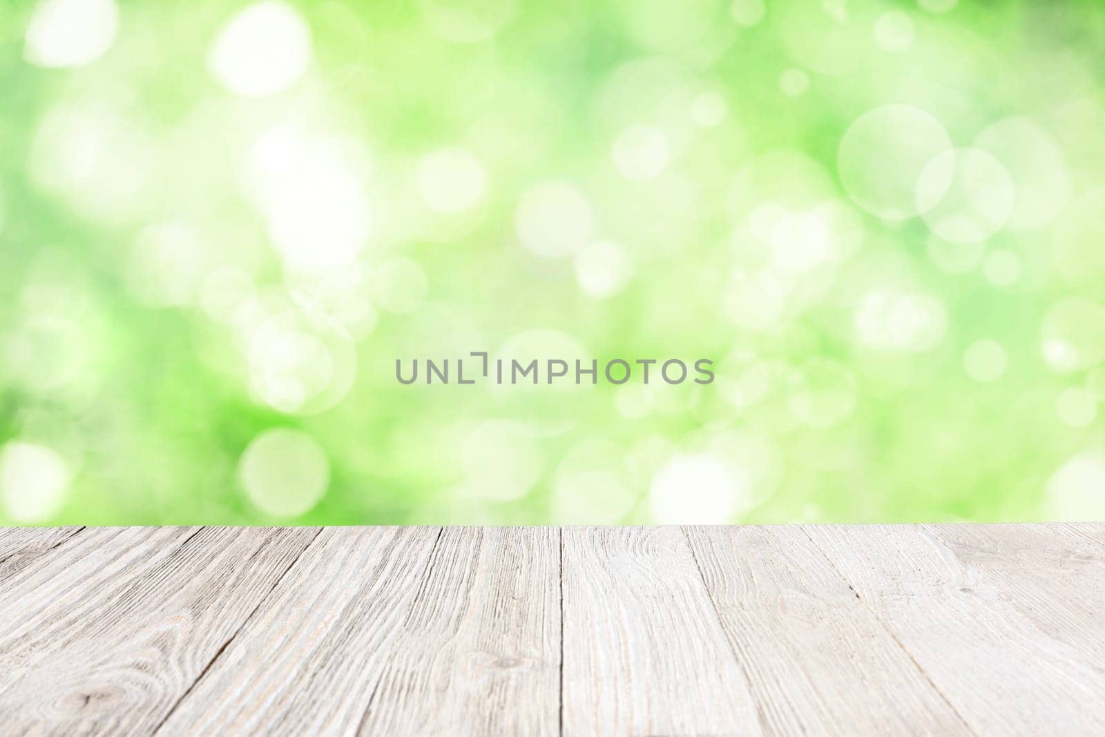 Wooden deck with blurred garden background