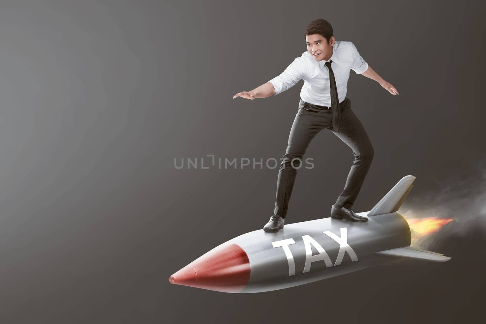 Young asian businessman on a rocket with Tax sign over gray background. Taxation concept