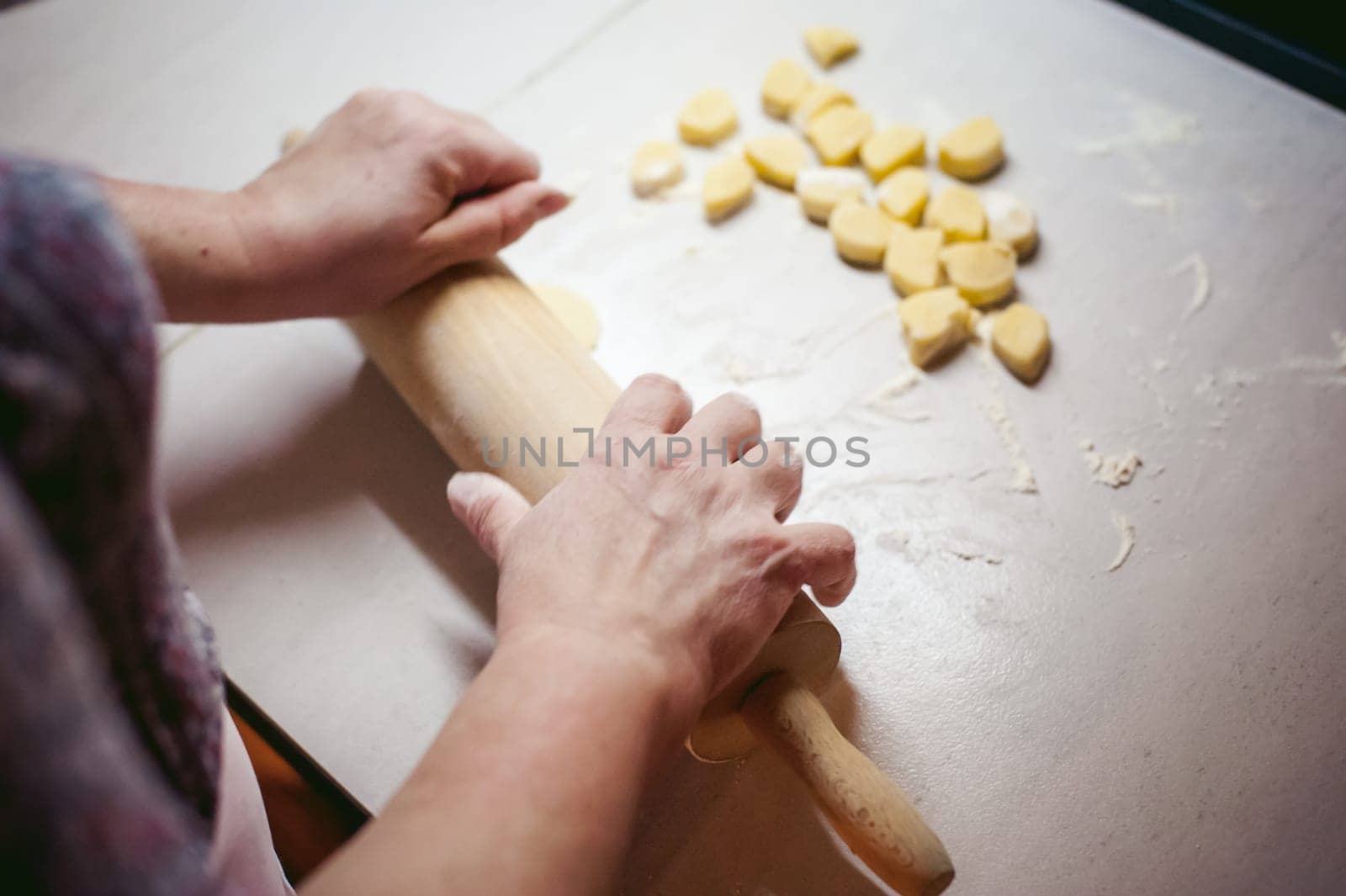 hand modeling dumplings at home in the kitchen. pelmeni lay on a baking sheet