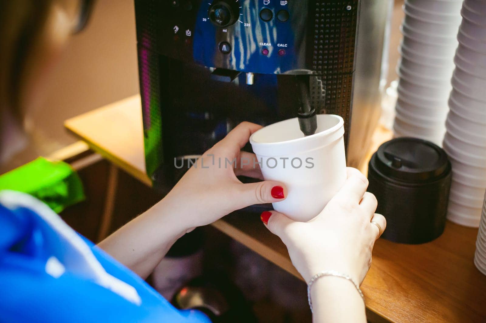 woman in cafe makes instant hot cocoa drink