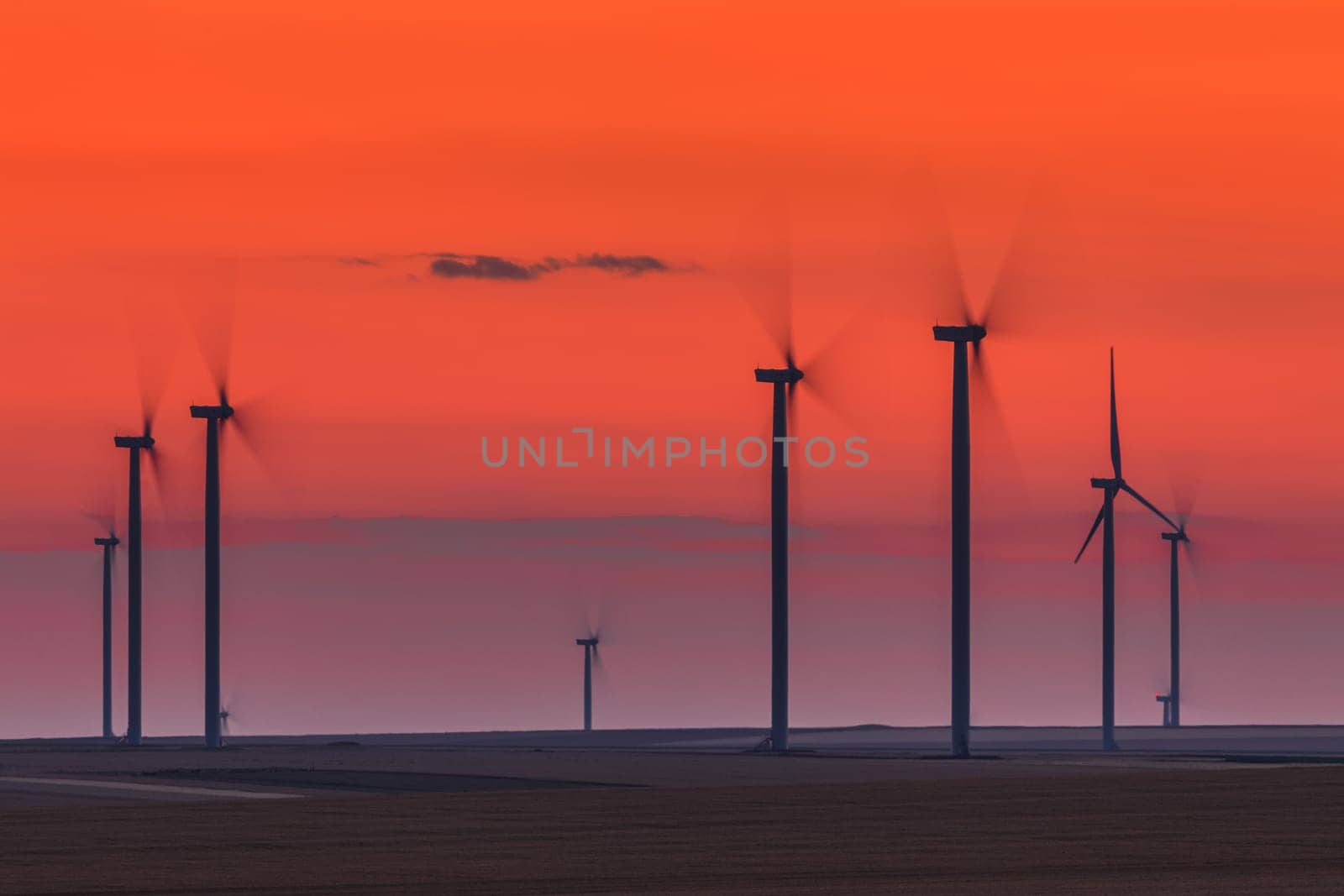 wind power turbines on a hill in sunset. Dobrogea Romania