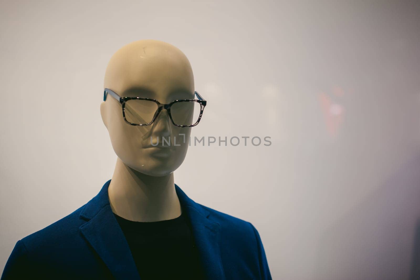 dummy on a shop window. Faceless man's glasses